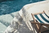 Serene poolside lounger with palm shadows, perfect for summer relaxation in Bali.