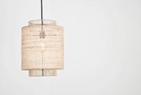 Elegant rattan pendant lamp with woven design against a stark white backdrop, perfect for interior decor inspiration.