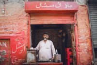 Portrait of a man at a traditional tea stall in Sadiqabad. Vibrant street scene with cultural elements.