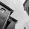 A low angle shot of urban buildings with a vintage architectural style in black and white.