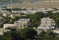 Dubai Hills Villas Best Luxury Villas For Modern Dubai Living An expansive aerial view of a residential community surrounded by greenery in Dubai, UAE.