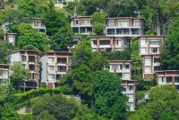 Green Villas Eco Luxury Villas Perfect For Sustainable Travel Tropical villas nestled on a lush hillside in Phuket, Thailand, showcasing vibrant greenery.