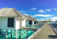 Ocean Villas Spectacular Oceanfront Villas For Luxury Escapes Scenic view of luxurious overwater bungalows on a sunny tropical day, ideal for travel and relaxation.