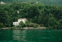 Charming villa by Lake Como surrounded by lush greenery in Lombardy, Italy.