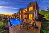 Villa Drago Stunning Luxury Estate Perfect For Elite Getaways Charming holiday villa with illuminated pool at sunset, ideal for relaxation and luxury retreats.